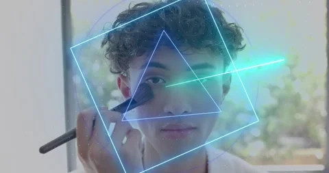 Man starting brushing right cheek with brush, blending on face, neon shapes Stock Footage 321143023