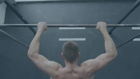 Man starting from contracted top and lowering slowly on pull-up bar for fitness Stock Footage 331062338