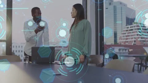 Man starting discussion by pointing at laptop, woman listening as data graphics Stock Footage 333509913