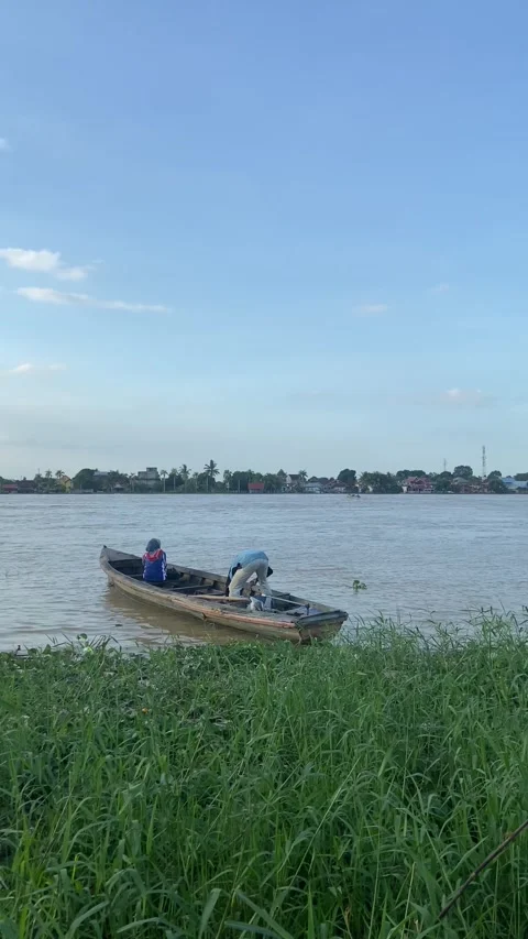 A man is starting the engine of boat Stock Footage 276676535