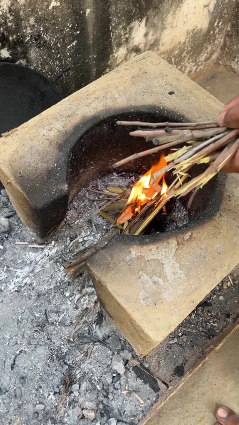 Man Starting Fire with Dry Twigs in Traditional Clay Wood Stove 스톡 동영상 332101618