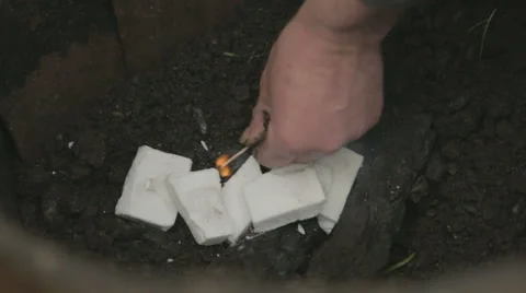 Man starting fire in a fire pit Stock Footage 58093657