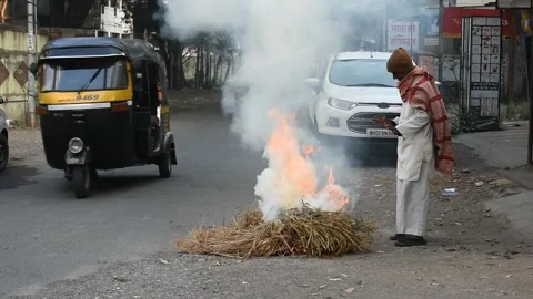 Man starting fire on street Stock Footage 170603469
