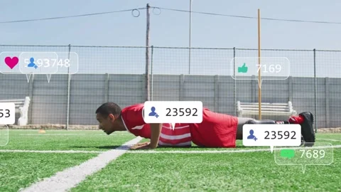Man starting high plank and doing pushups on turf while training with icons Stock Footage 333720179