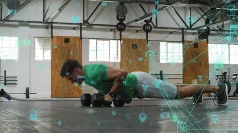 Man starting plank, alternating rows and pushups on weights for fitness, teal Stock Footage 333859826