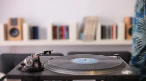 A man starting a retro record player Stock-Footage 58339027