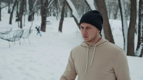 Man starting running in cold winter park Stock Footage 148105414