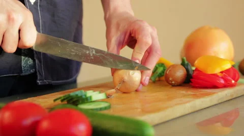 Man starting to slice up an onion Stock Footage 41014337
