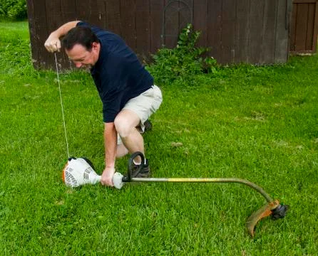 Man Starting A String Trimmer 写真素材