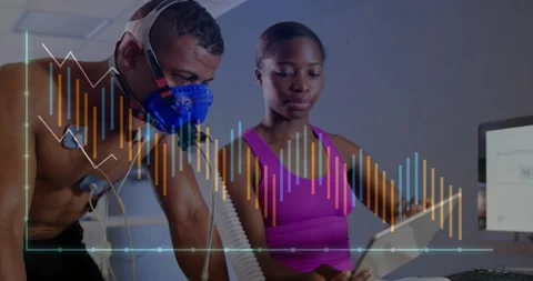 Man starting test, causing tech tapping tablet, waveforms shifting, mask and ECG Stock Footage 330563481
