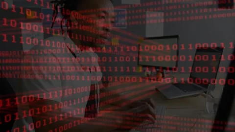 Man starting typing and analyzing data at tech desk while red binary overlay Stock Footage 330192077