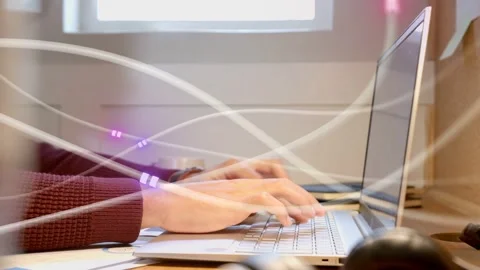 Man starting typing as hands move, coding while purple LED trails crossing hands Stock Footage 333734998