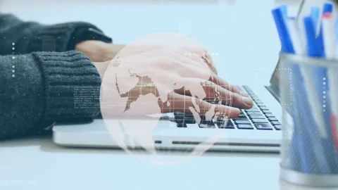 Man starting typing on laptop, activating faint globe and HUD elements showing Stock Footage 335282997