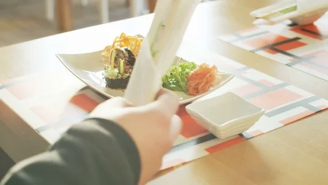 Man Starting to Use Chopsticks Stock Footage 71423060