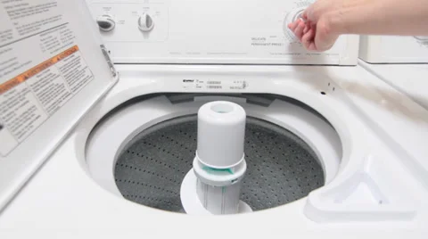 Man Starting to Wash Clothes in Machine 스톡 동영상 34481161