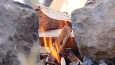 Man starting a wood fire while camping outdoors Stock Footage 90915314