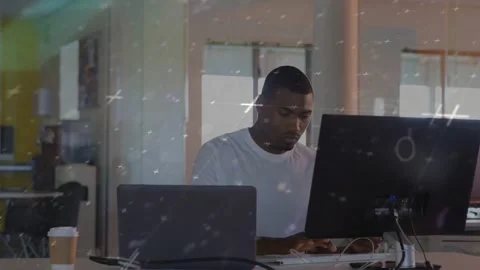 Man starting work, typing and shifting gaze between dual screens in tech while Stock Footage 332275906