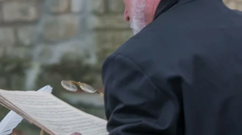 Man starting to write a poem at a stone table Stock Footage 46873286