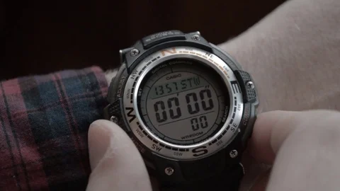 A man starts and stops the stopwatch on the wristwatch Stock Footage
