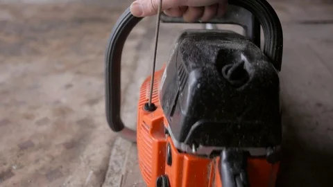 Man starts chainsaw Stock Footage 75369954
