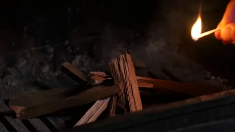 Man starts fire in fireplace Stock Footage 74224417