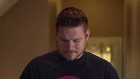 A man starts to light a cigarette but throws it away. Stock Footage 69944942