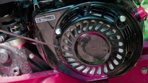 A man starts a motorcycle cultivator for processing a land plot Stock Footage 245260910