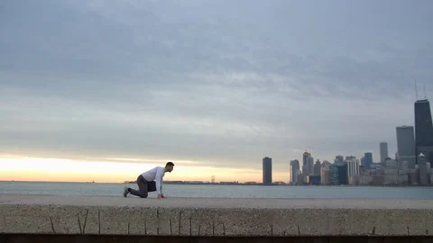 Man starts running from the set position. Man is running on the ebankment Video stock 82647607