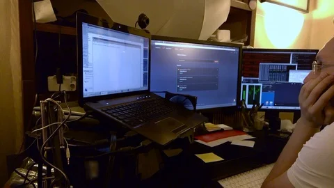 A man starts a stream while sitting at a computer whith multi screens Stock Footage 101988377