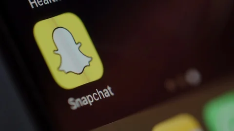 Man starts using Snapchat on a smartphone Stock Footage 102443435