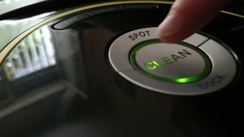 A man starts vacuum cleaner robot Man at home concept 4K Stock Footage 134932151