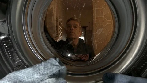 A man starts a washing machine, close up view from inside Stock Footage 103165833
