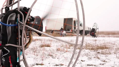 Man starts to work a propeller, motor, engine of the paramotor paraglider Stock Footage 147497730