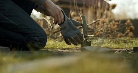 Man starts working in the garden at the backyard Stock Footage 128321108
