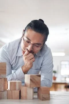 Man in startup with building blocks, thinking of vision, games and design Fotos de archivo