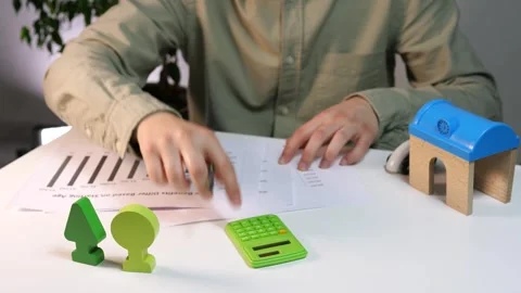 A man with statistical data and indicators, reads them, recalculates. Stock-Footage 311540816