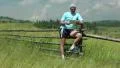 Man staying near wooden fence, talking on skype, smiling and gestures HD Footage