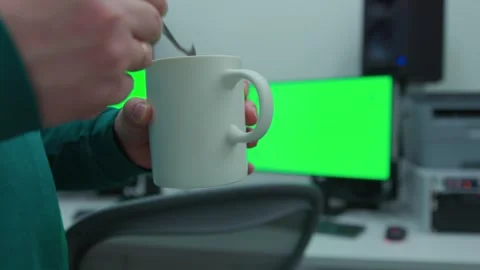 A man staying in the scene with a cup of tea in his hand and stir it Video stock 272458366