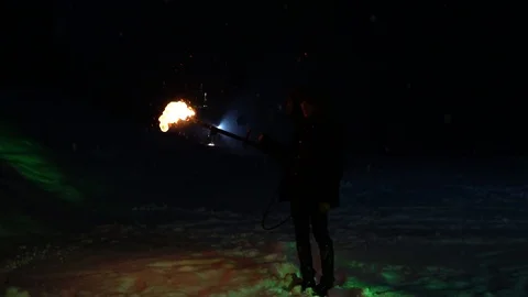 Man stays in darkness with TORCH. Winter night and fire. Fireshow at the winter Video stock 121580322