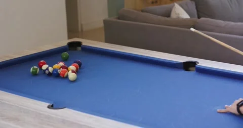 Man steadying cue ball on pool table before striking, initiating break to start Stock Footage 337224401