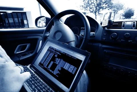 Man stealing data from a laptop Stock Photos
