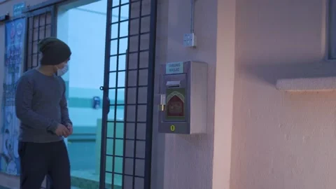 A man stealing 'tabung masjid' mosque funds at night Stock Footage 143844709