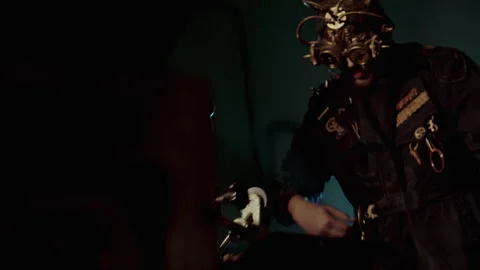 A man with a steampunk mask in a coat operating a machine Stock Footage 259856490