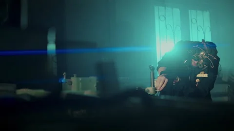 A man with a steampunk mask fixing a machine Stock-Footage 259857086