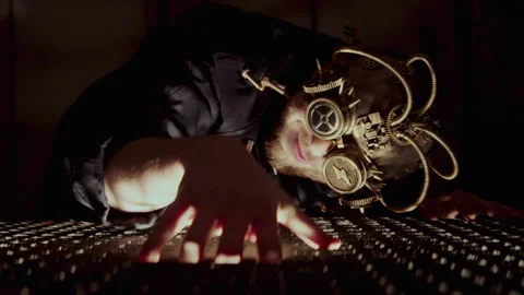 A man with a steampunk mask playing with a machine with his hand Stock-Footage 259855331