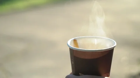 Man stear hot tea in the cup in the morning outdoors, close up, 4k Video stock 95498061