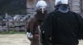 Man in steel helmet with chain mail mask attacking rival in violent sword fight HD Footage