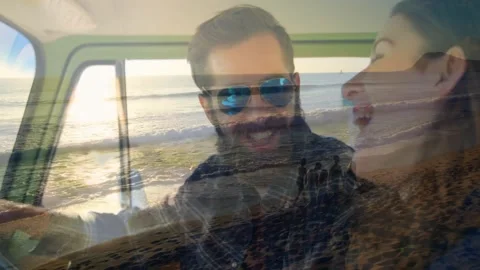 Man steering and smiling, sparking woman leaning and laughing, ocean waves Stock Footage 330443784