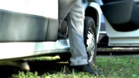 Man stepping down from a van and shutting the door. Stock Footage