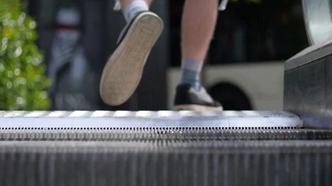 Man stepping off escalator, slow motion Stock Footage 75818427